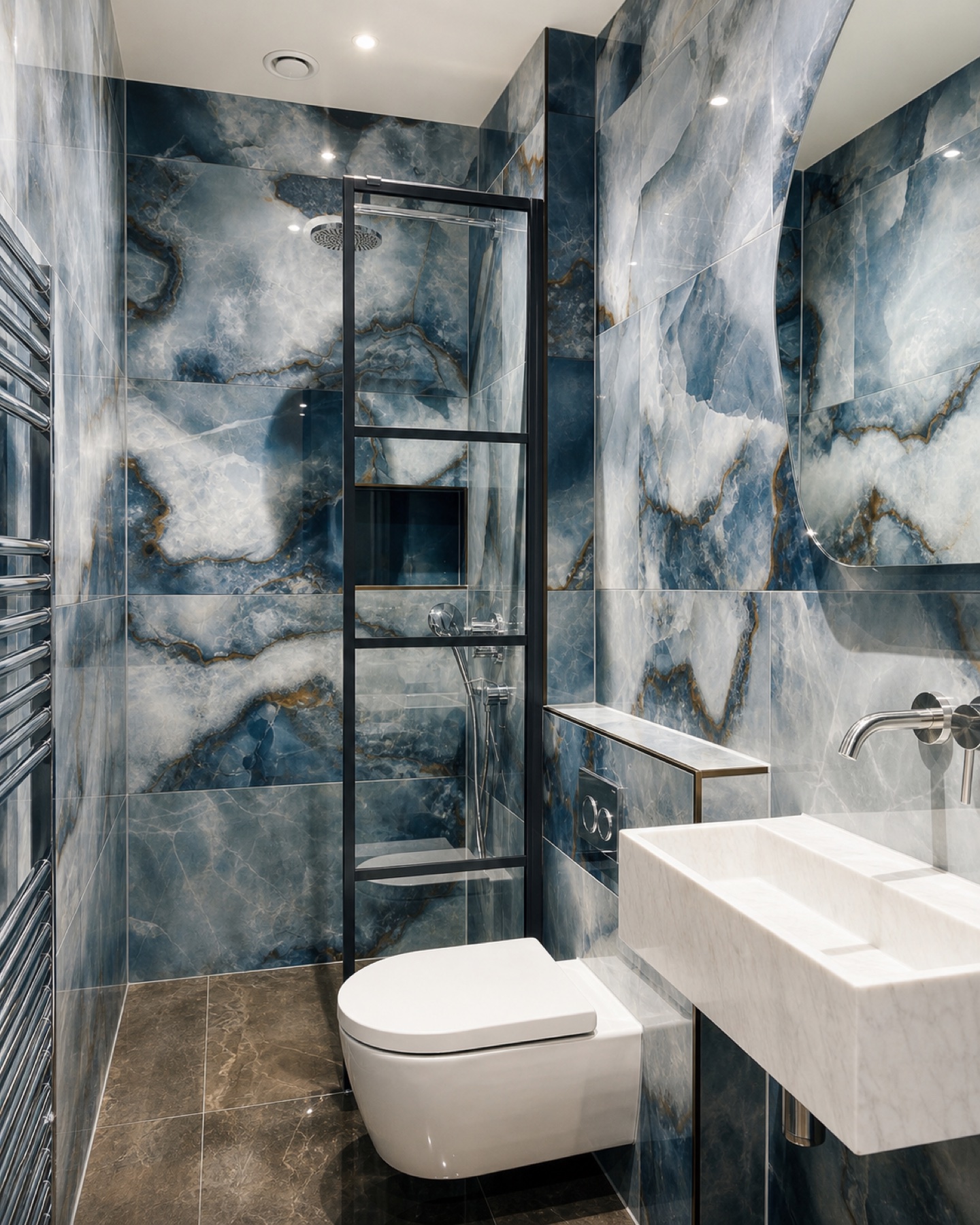 Full view of the completed blue stone bathroom with shower, wall-hung WC and stone basin