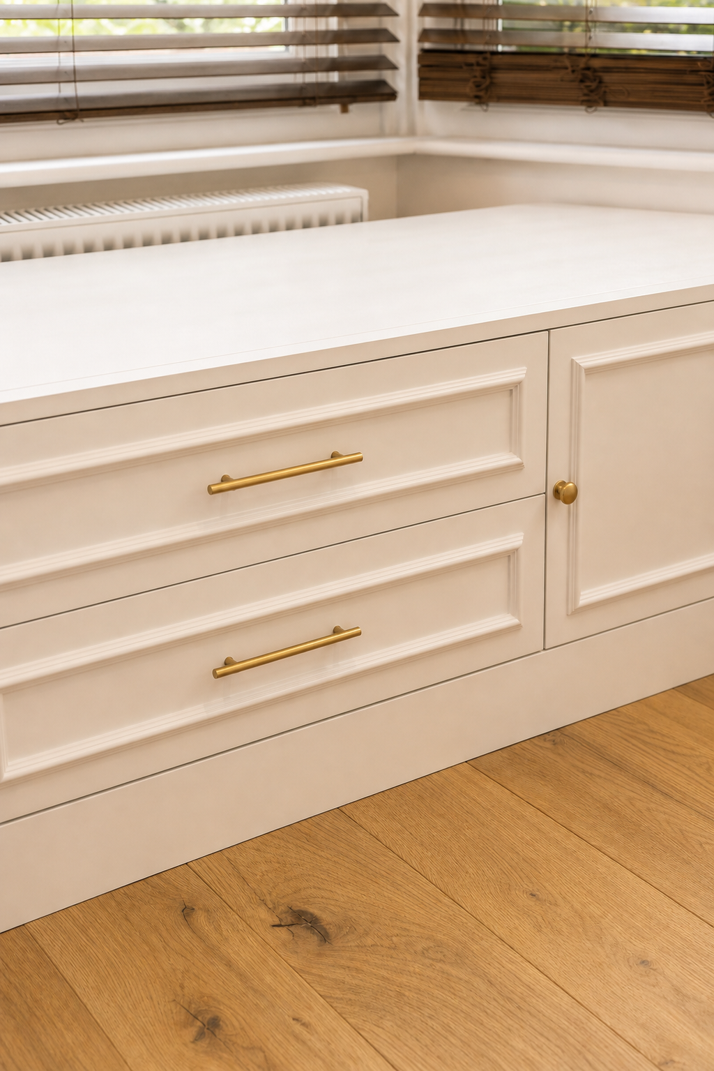 Close three-quarter view of the two central fitted drawers, right cupboard and brushed-brass hardware