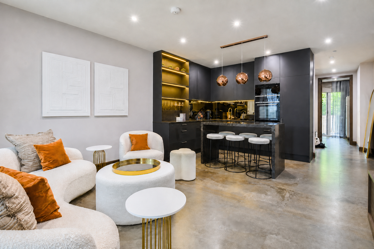 Sculptural white seating and the dark kitchen within the finished living space