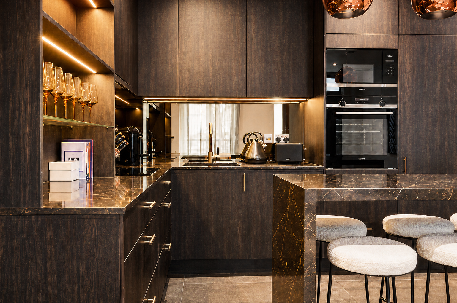 Detailed front view of the dark bespoke kitchen and marble breakfast bar