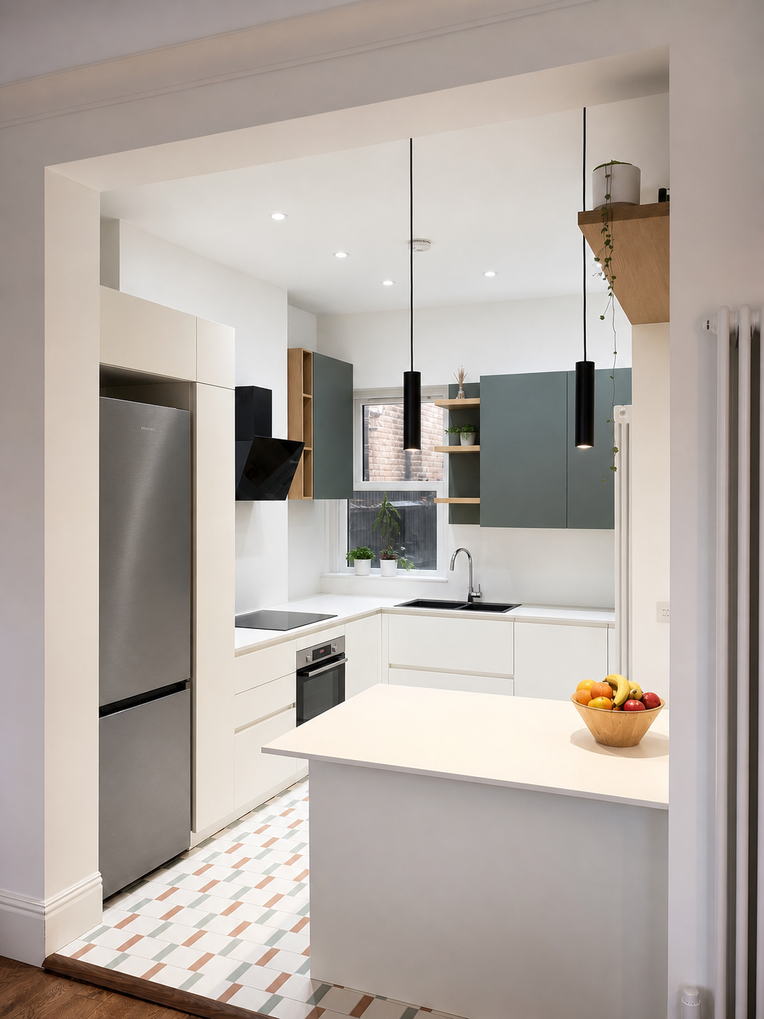 Completed compact London kitchen with warm-white cabinetry, muted sage upper cabinets and natural oak shelving