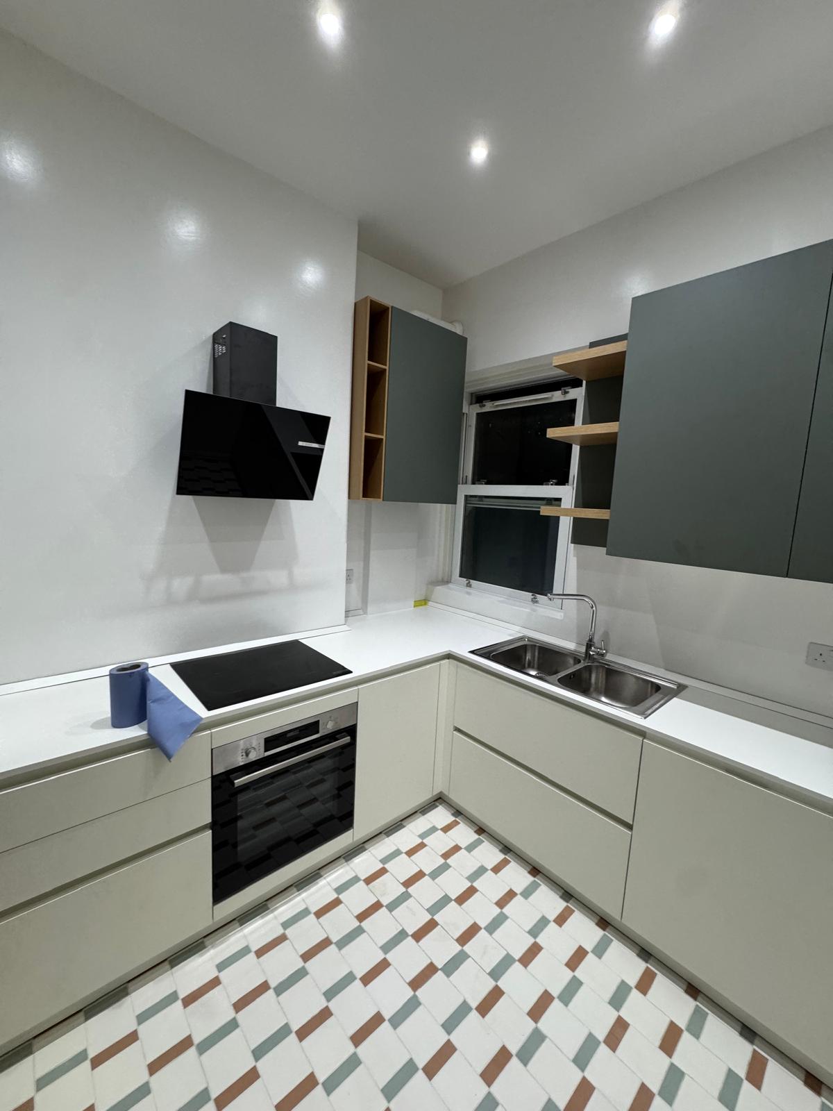 New L-shaped kitchen installed before the final clean and styling
